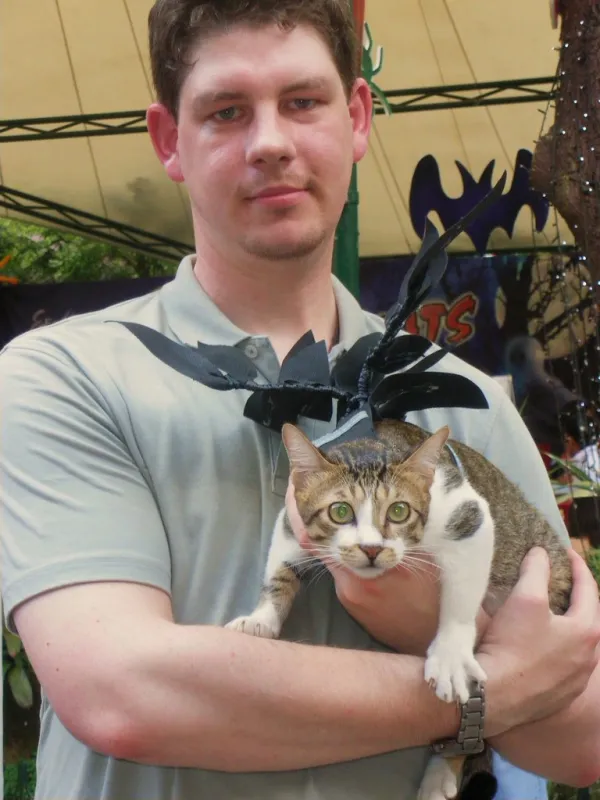 A neighbor obliged with a photo of himself and a beautiful if not petrified stray cat he adopted