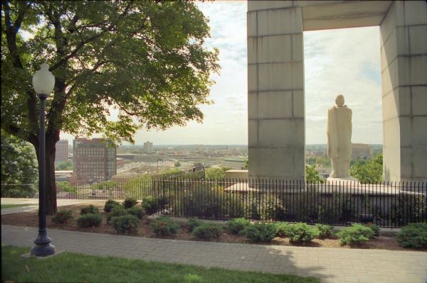 B_15A College Hill - Prospect Terrace (1867) - 75 Congdon Street - Lamp Post and Arch with Roger Williams Statue (1939) as Frames - St. John's Roman Catholic Church (1871) (Federal Hill) – 352 Atwells Avenue (at Sutton Street) Centered in the Distance
