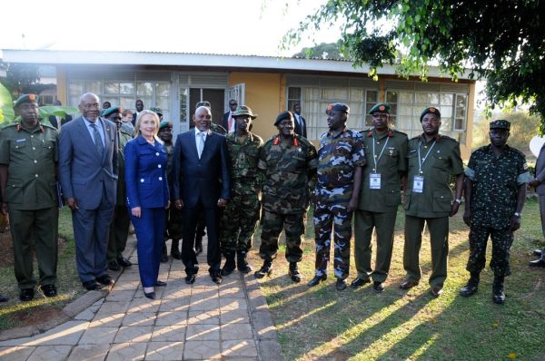 U.S. Secretary of State Hillary Rodham Clinton poses for a photograph with the U.S. Assistant Secretary of State for African Affairs Johnnie Carson and members of the Uganda People’s Defense Force (UPDF), at the UPDF's Kasenyi military base in Kampala, Ug