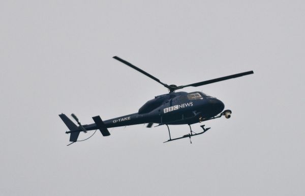 BBC News helicopter watching over the cuts protest