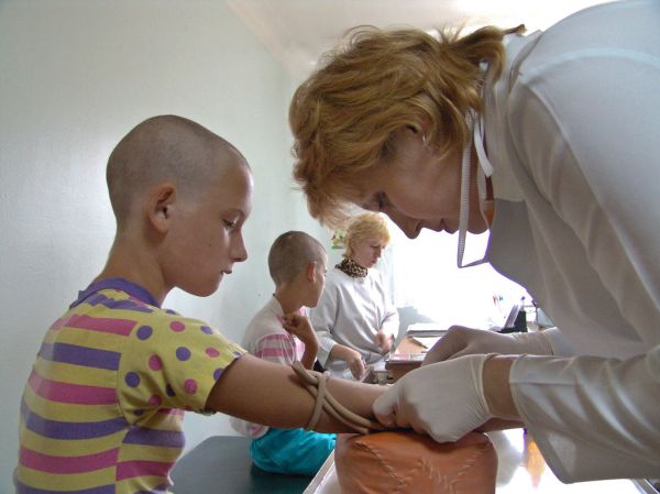 Children being tested for AIDS by a doctor