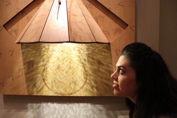 Artist Christy Oates with her piece 'Mosquito Lamp'