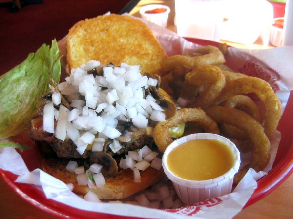 1/2 lb 'the works' hamburger with onion rings from fuddruckers