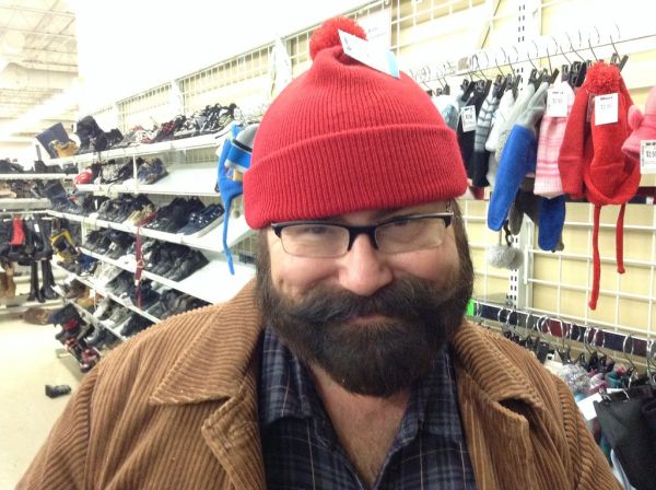 Mike Mozart with Beard and Mustache trying on a hat