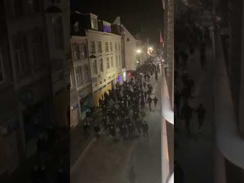 Football hooligans in Netherlands patrolling the streets of their city tonight to stop looting gangs