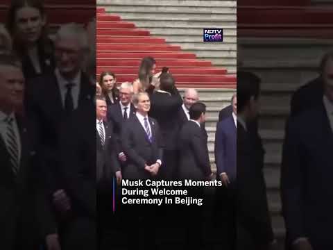 Elon Musk Seen Spinning Around While Capturing Moments During the Welcome Ceremony in Beijing